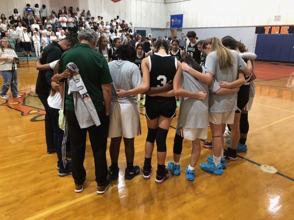 Players from Boca Raton Christian and Berean Christian gather for a moment of prayer after the District 14-2A championship Friday night in West Palm Beach.