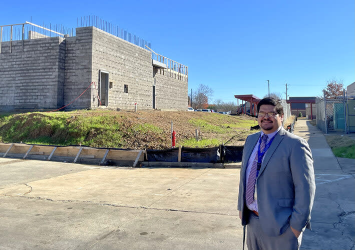 Nicholas Dominguez, principal of Macon Hall Elementary School, stands near a new 10-classroom addition paid for with relief funds. (Linda Jacobson/The 74)