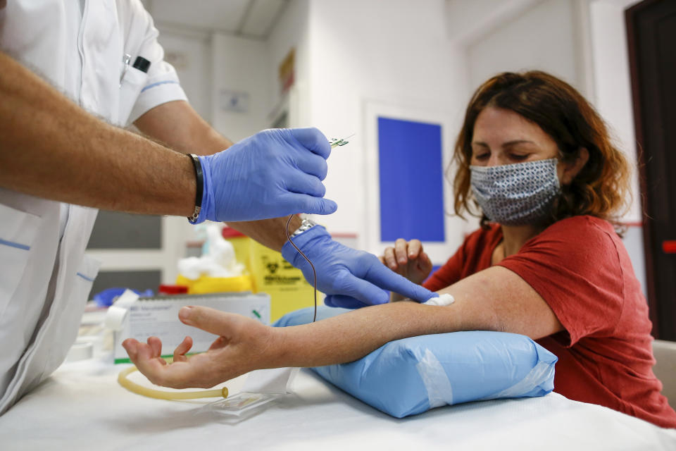 A teacher of the Melissa Bassi school takes the COVID-19 serological test in a medical centre in Rome, Wednesday, Sept. 2, 2020. All teachers are supposed to be tested before the start of the school year. (Cecilia Fabiano/LaPresse via AP)