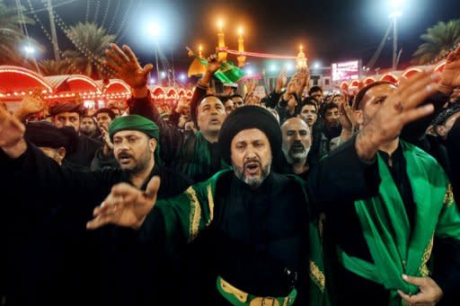 Shiite Muslims gather outside the shrine of Imam Abbas in Karbala early on Sunday. Throngs of pilgrims beat their chests and some used swords to make cuts on their heads as a sign of mourning for Imam Hussein, grandson of the Prophet Mohammed who was killed in 680 AD by the armies of the caliph Yazid