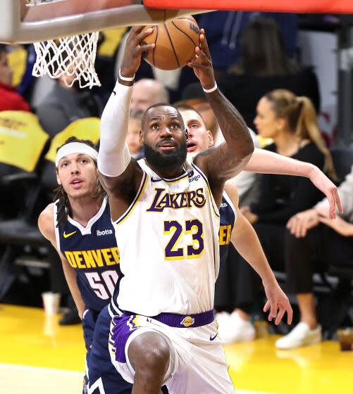 LOS ANGELES, CALIFORNIA – APRIL 27: Lakers LeBron James passes Nuggets Aaron Gordon.