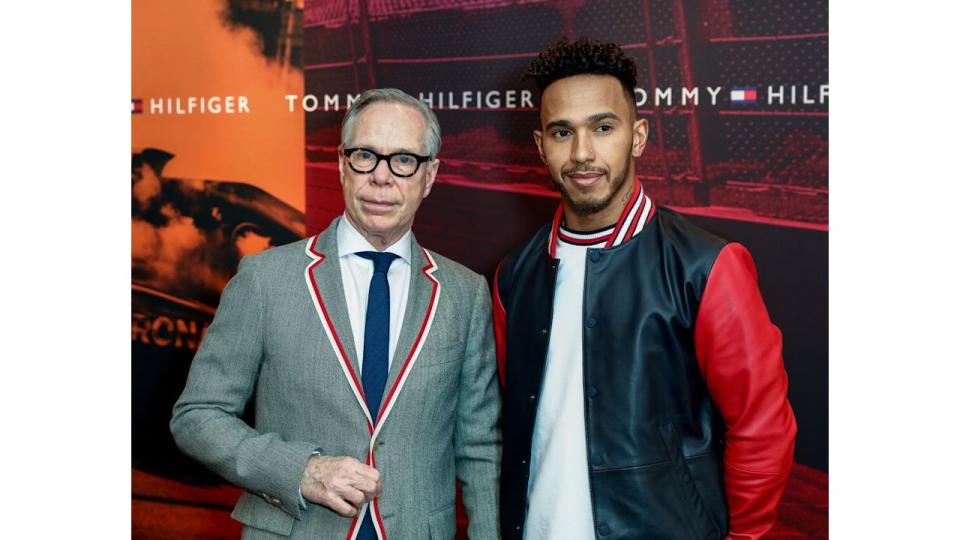 A man standing with Lewis Hamilton at a Tommy Hilfiger event