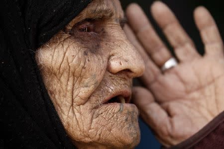 Khatla Ali Abdullah, 90, who recently fled her house in Al Mamoun district speaks with a Reuters journalist as she sits at her tent in Hammam al Alil camp, while Iraqi forces battle with Islamic State militants, in western Mosul, Iraq March 1, 2017. REUTERS/Zohra Bensemra