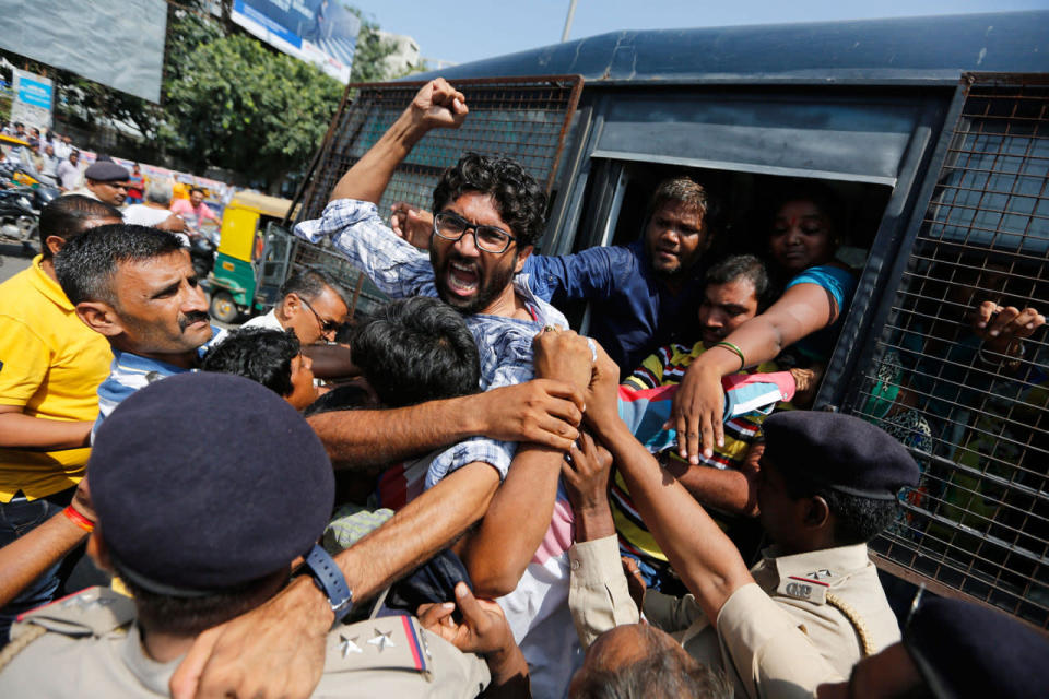 <p>Policemen detain Dalit leader Jignesh Mevani during a protest by sanitation workers in Ahmadabad, India, Tuesday, Sept. 27, 2016. Mevani, a leader of the lowest rung of India’s caste hierarchy, joined a protest demanding permanent jobs for sanitation workers who had been employed on contract basis for several years in the Ahmadabad Municipal Corporation. (AP Photo/Ajit Solanki)</p>