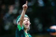 <p>An excited young fan salutes the team </p>