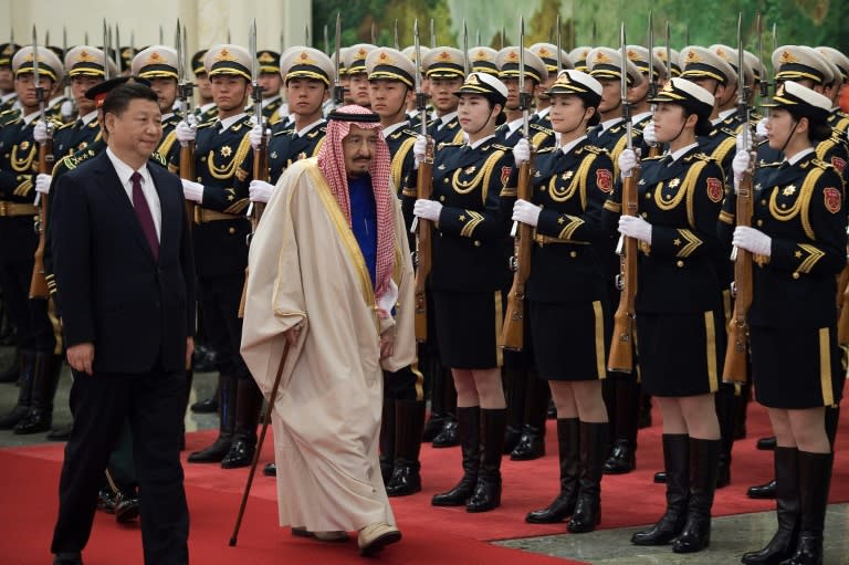 Saudi King Salman bin Abdulaziz (centre) reviews an honour guard during a welcoming ceremony at the Great Hall of the People in Beijing, on March 16, 2017