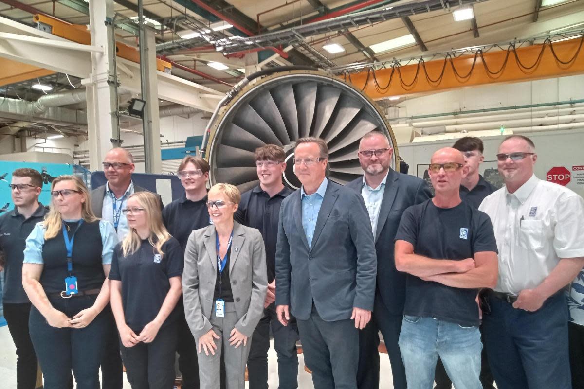David Cameron with health minister Andrew Stephenson and current and recent apprentices in front of a Rolls Royce RB211 aircaft engine