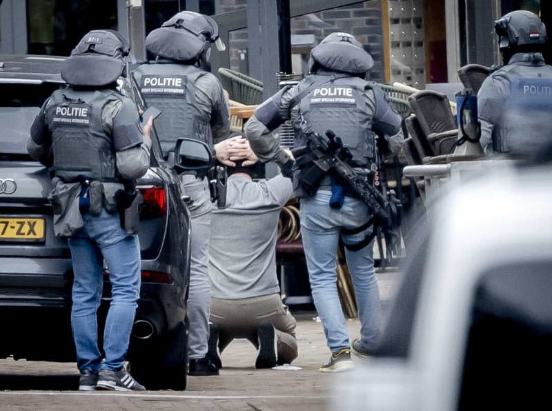 A man is arrested by the DSI, a special unit of the Dutch police, outside a cafe in Ede. Several people were taken hostage in a cafe in the Dutch city of Ede near Utrecht on Saturday. Remko De Waal/ANP/dpa
