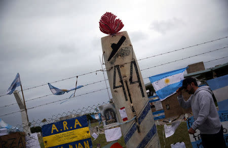 A man walks past signs and messages in support of the 44 crew members of the missing at sea ARA San Juan submarine, placed on a fence at an Argentine naval base in Mar del Plata, Argentina November 23, 2017. REUTERS/Marcos Brindicci