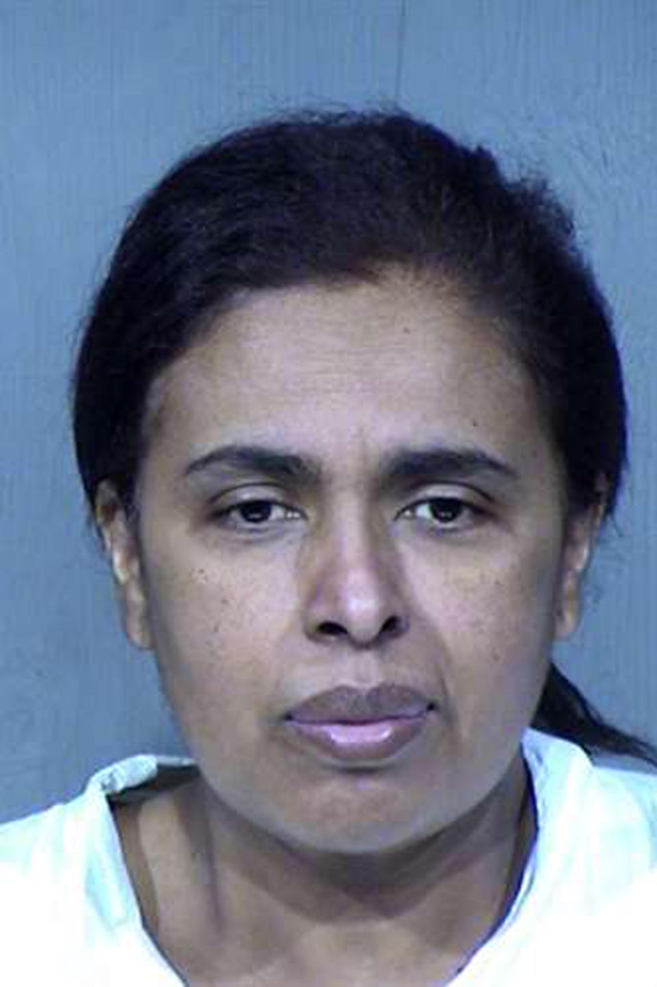 This undated booking photo provided by the Maricopa County Sheriff's Office shows 50-year-old Maribel Loera. Loera and her husband, 56-year-old Rafael Loera, are accused of intentionally setting their west Phoenix home ablaze after their children were taken by the state, leading firefighters to find unidentified skeletal remains. They have been booked on suspicion of arson, child abuse and concealment of a dead body. Authorities haven't determined whether the remains belong to a child or adult. (Maricopa County Sheriff's Office via AP)