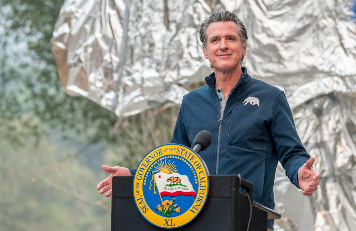 California Gov. Gavin Newsom speaks to media Thursday, September 23, 2021 in Sequoia National Park before signing a $15 billion climate package into law that will help bolster the state's response to climate change.