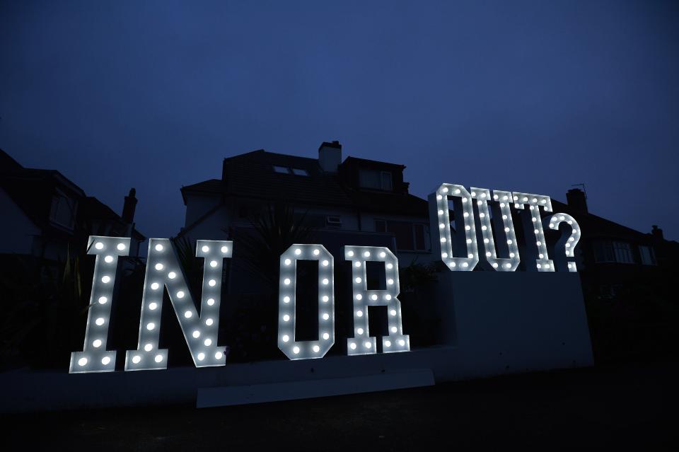 An illuminated 'In or Out' sign is pictured outside a house in Hangleton near Brighton in southern England, on June 23, 2016, as Britain holds a referendum on whether to stay or leave the European Union (EU).