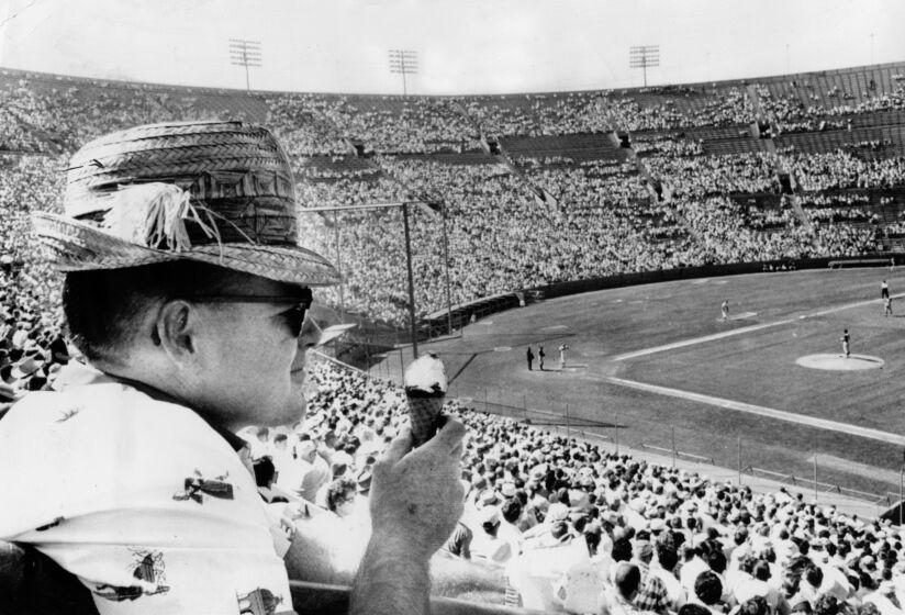 April 17, 1961: Los Angeles Dodger fan eats ice cream cone during game at the Los Angeles Memorial Coliseum.