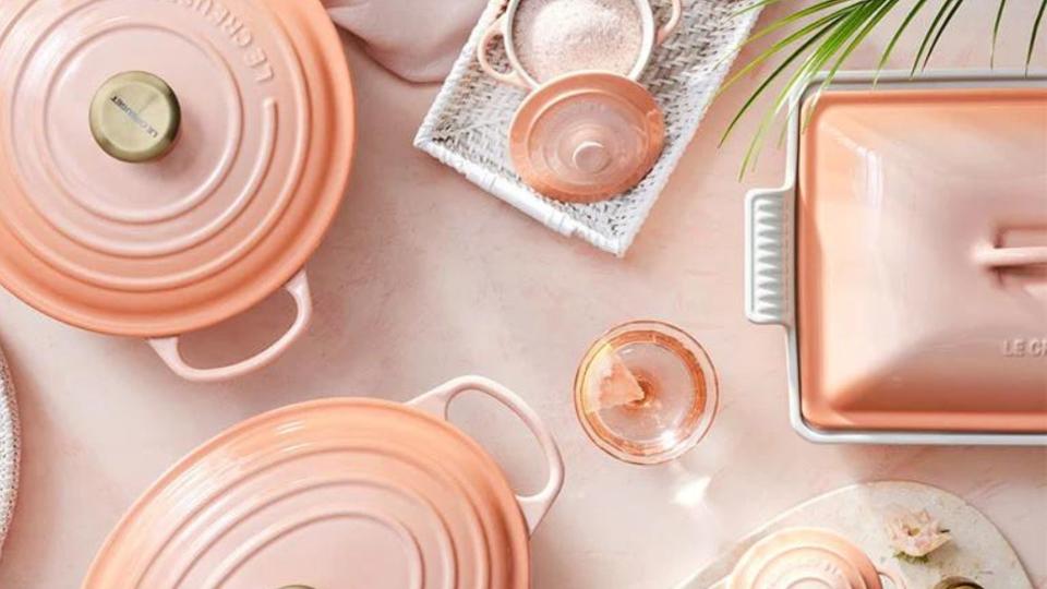 Le Creuset cookware in the new peach color on a peach table. 