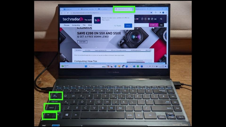  How to switch tabs in a web browser - Photo of a laptop with keys and browser tab highlighted