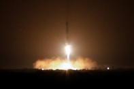 SpaceX Falcon Heavy rocket boosters return to the ground after helping launch the U.S. Air Force's Space Test Program 2 Mission from the Kennedy Space Center in Cape Canaveral