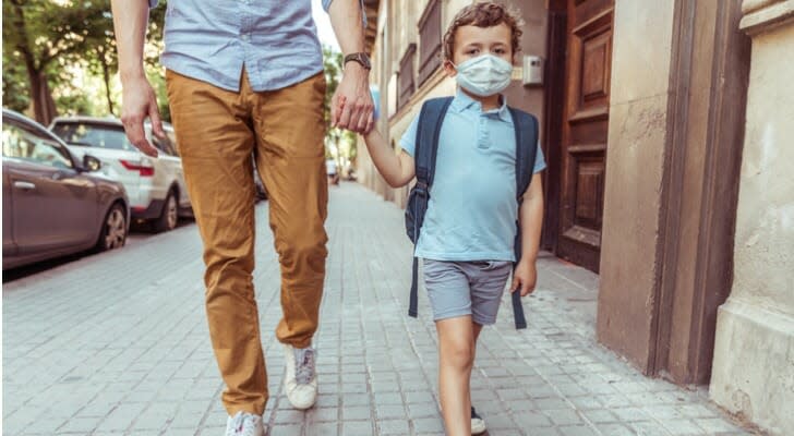 Dad walking son to elementary school