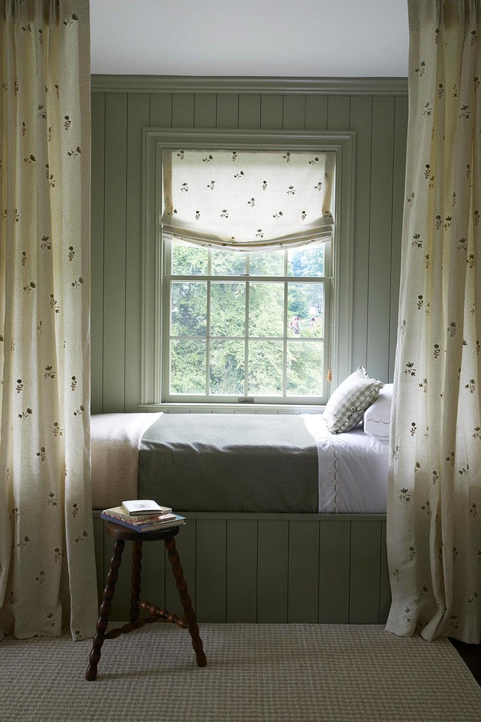 Sage green room with day bed and curtains.