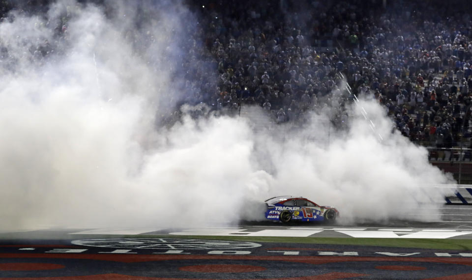 Martin Truex Jr. celebrates after winning the NASCAR Cup Series auto race at Charlotte Motor Speedway in Concord, N.C., Sunday, May 26, 2019. (AP Photo/Chuck Burton)