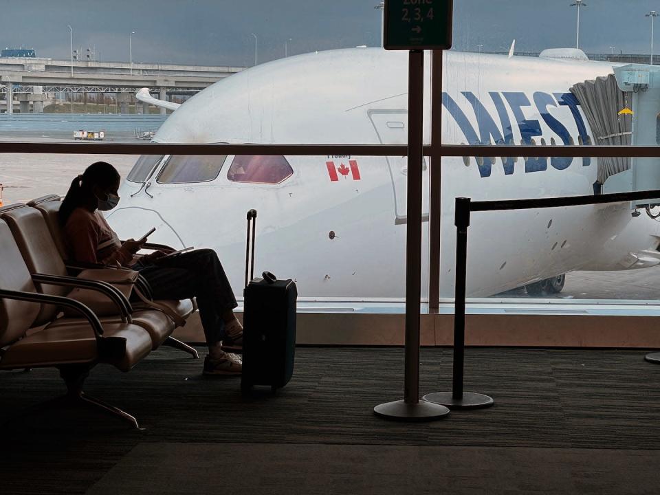 A passenger waits to board a flight at Toronto Pearson International Airport.