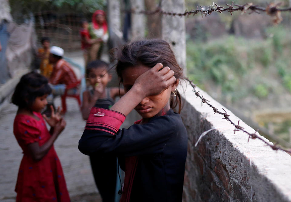 Rohingya refugee girl wipes her eyes in Teknaf