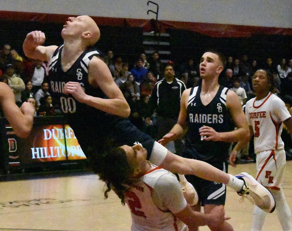 Somerset Berkley's Max Finlaw and Durfee's Davontae Stewart meet at the net during a recent game at Durfee Dec. 15, 2023.