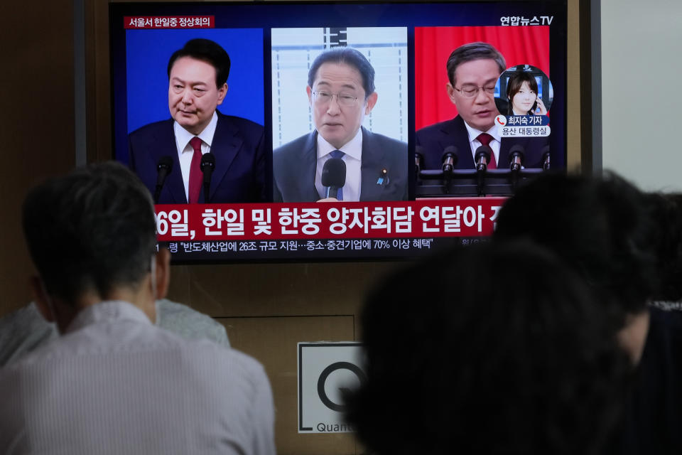 A TV screen shows file images of South Korean President Yoon Suk Yeol, left, Japanese Prime Minister Fumio Kishida and Chinese Premier Li Qiang, right, during a news program at the Seoul Railway Station in Seoul, South Korea, Thursday, May 23, 2024. Leaders of South Korea, China and Japan will meet next week in Seoul for their first trilateral talks in more than four years, South Korea's presidential office announced Thursday. (AP Photo/Ahn Young-joon)