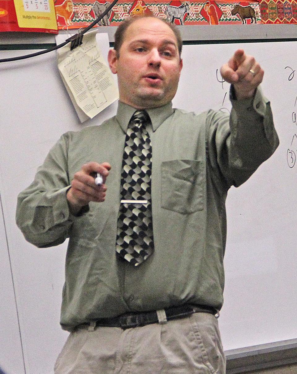 Math teacher Michael Falk answers questions from his seventh-grade class at St. Mary’s Visitation School in Elm Grove in 2014. Falk, who also led the school's Quiz Bowl, was a contestant in a "Battle of the Decades" competition on "Jeopardy!" that year after winning a four-day run on the show in 2006.