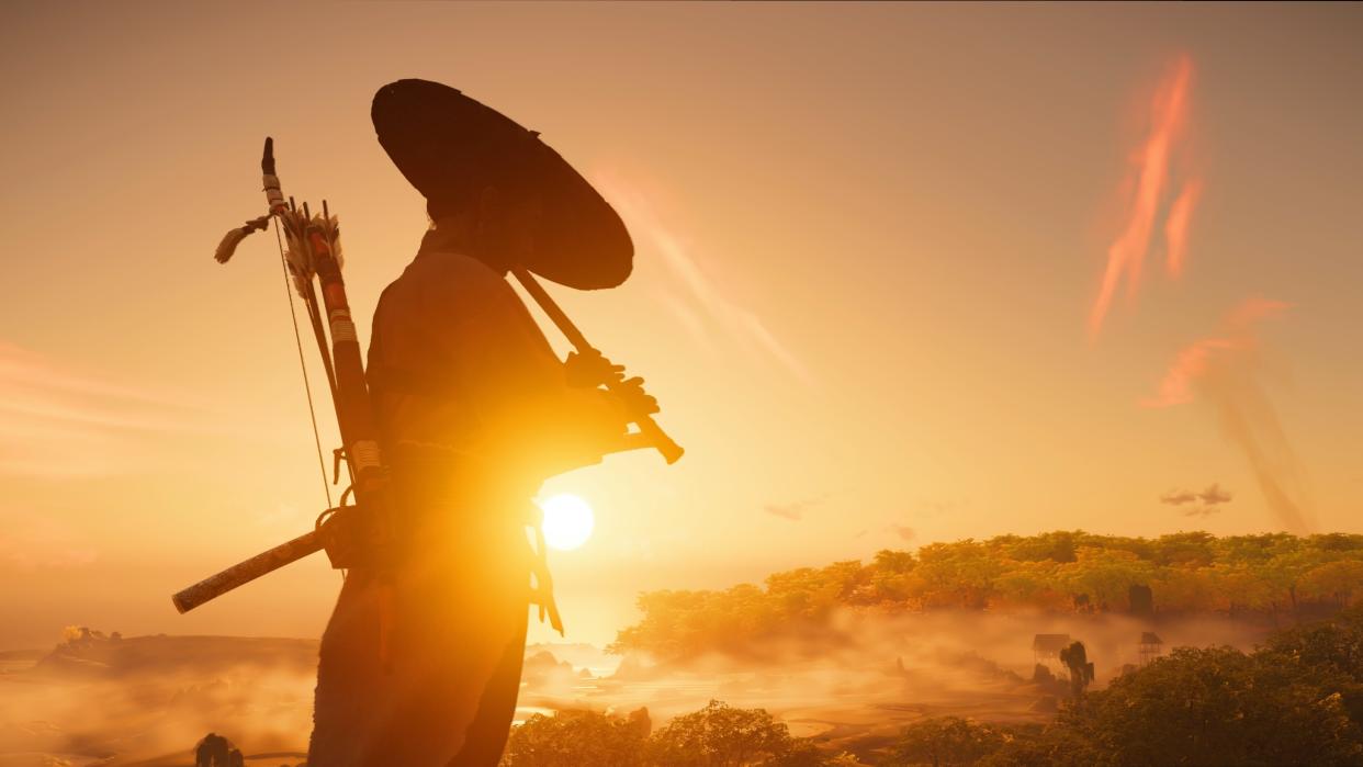  A silhouetted figure plays a flute against a setting sun backdrop. 