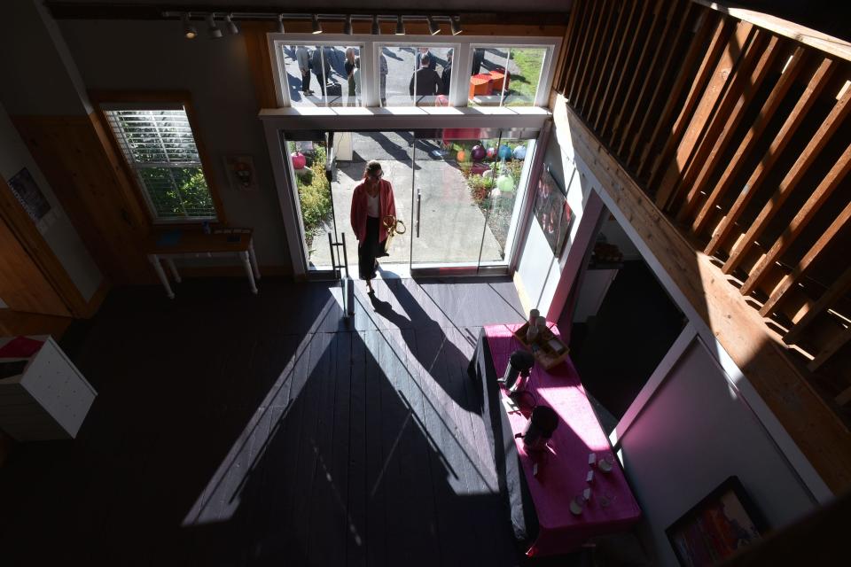 Liz DiGirolamo, with the Cape Cod Chamber of Commerce, heads into the Guyer Barn, after an opening ceremony at the HyArts Campus.