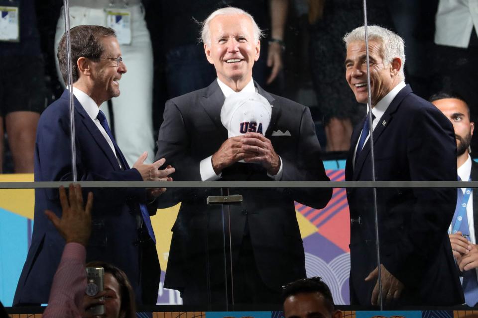 President Joe Biden, Israeli President Isaac Herzog (L) and Israel's caretaker Prime Minister Yair Lapid attend the opening ceremony of the Maccabiah Games at Teddy Stadium in Jerusalem on July 14, 2022.