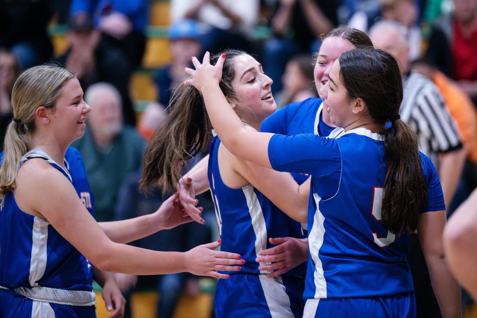 West Boylston players congratulate Maddie Pitro, center, after scoring her 1,000th point during the Clinton Holiday Tournament on Friday.