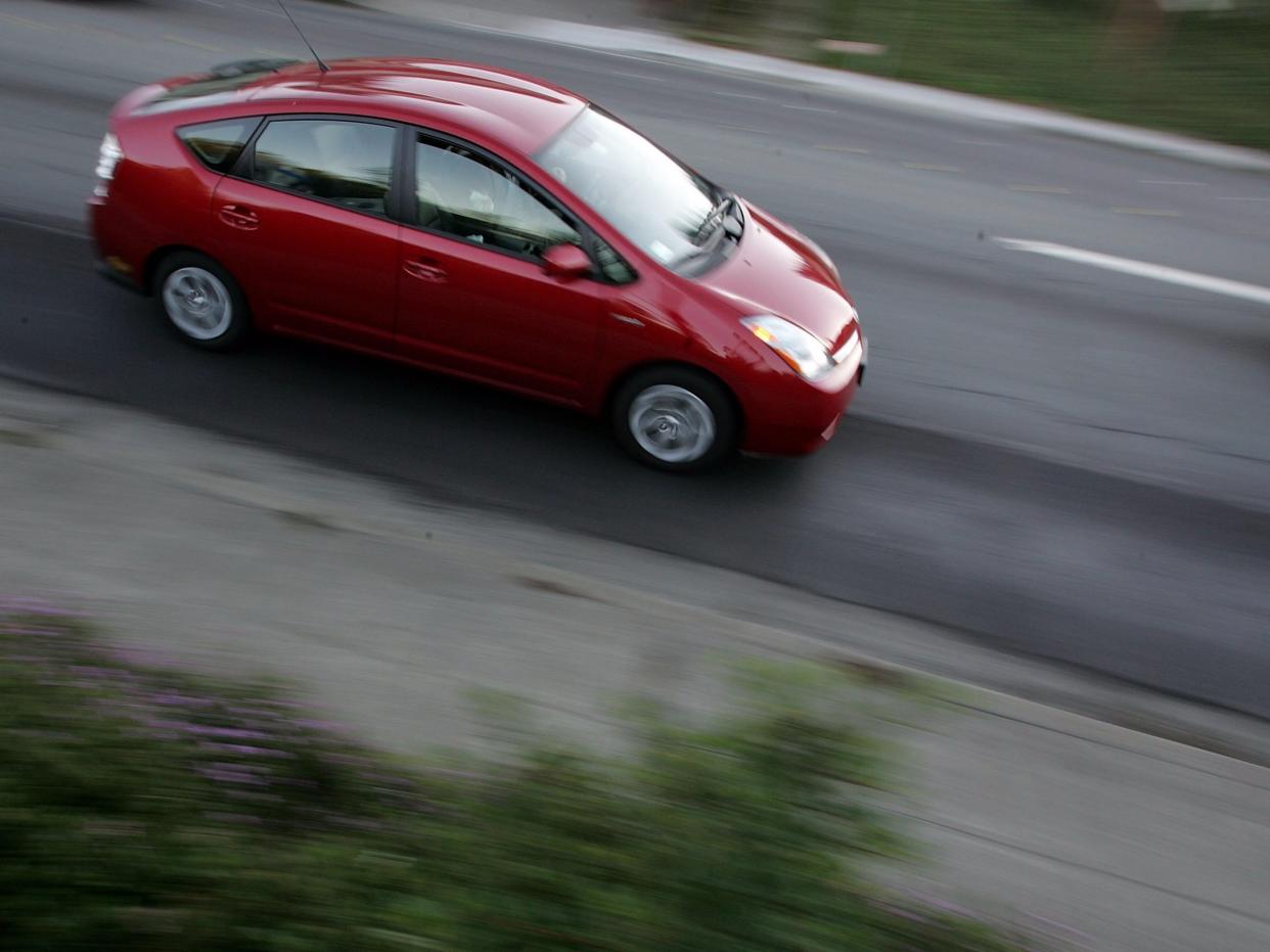 toyota prius uber car driving road highway