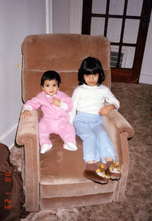 The author as a child, bundled up in warm PJs on a recliner next to her brother on a typically cold Pennsylvania day. (Photo: Courtesy of Salina Jivani)