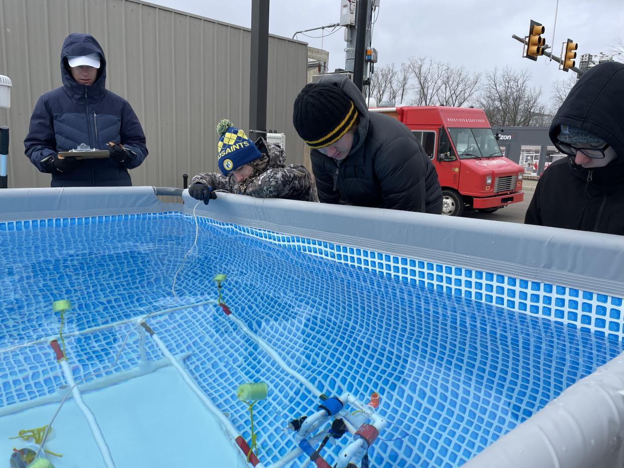 Clinton High School's Team Bazooka Space Sharks, from left, Zak Shadley, Jacob Gilson and Caden Arntz, operate a robot on the Mission Course during the Michigan Regional SeaPerch Underwater Robotics Competition March 18 at the University of Michigan in Ann Arbor.