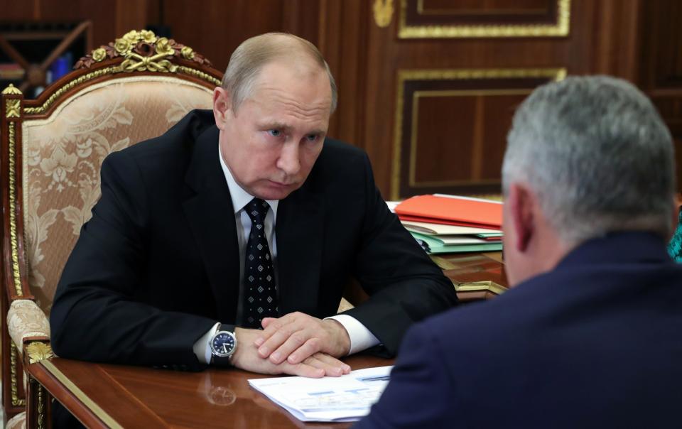 Russian President Vladimir Putin, left, listens to Russian Defense Minister Sergei Shoigu during their meeting in the Kremlin in Moscow, Russia, Thursday, July 4, 2019. Some crew members survived a fire that killed 14 sailors on one of the Russian navy's deep-sea submersibles, Russia's defense minister said Wednesday without specifying the number of survivors from the blaze. (Mikhail Klimentyev, Sputnik, Kremlin Pool Photo via AP)