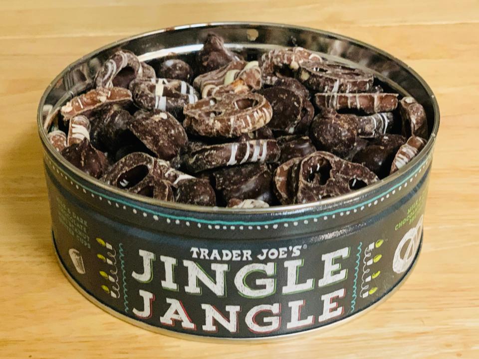 Trader joe's jingle jangle snack mix in green tin on wood table
