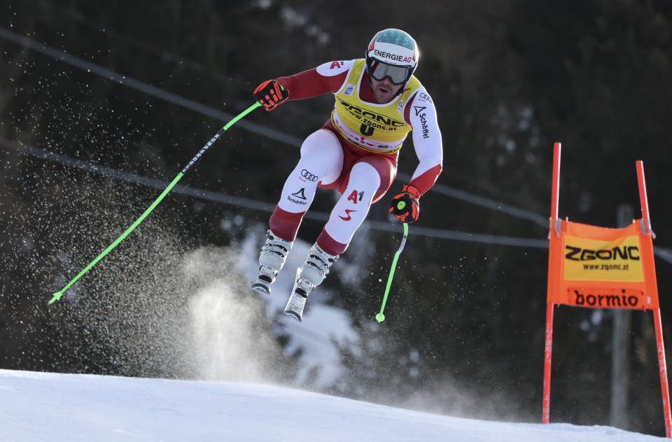 FILE - Austria's Vincent Kriechmayr is airborne during an alpine ski, men's World Cup downhill race, in Bormio, Italy, Wednesday, Dec.28, 2022. Once known as skiing’s “Wunderteam” for its domination of the ski racing circuit, Austrian men and women have both been struggling for results this season while Austrian coaches are lending their expertise to other nations. (AP Photo/Marco Trovati, File)