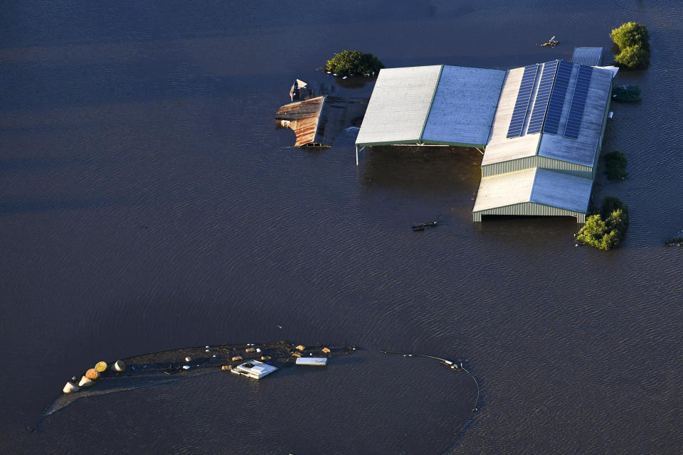 Buildings are partially submerged as floodwater covers large areas northwest of Sydney, Australia, Wednesday, March 24, 2021. Some 18,000 residents of Australia's most populous state have fled their homes since last week, with warnings the flood cleanup could stretch into April. (Lukas Coch/Pool Photo via AP)