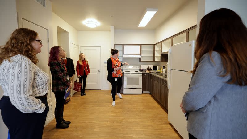 State employees are shown one of the rooms at the Central City Apartments. The Utah Homeless Council and Utah Office of Homeless Services launched the state’s new strategic plan to address homelessness statewide during a press conference at First Step house in Salt Lake City on Monday, March 13, 2023.