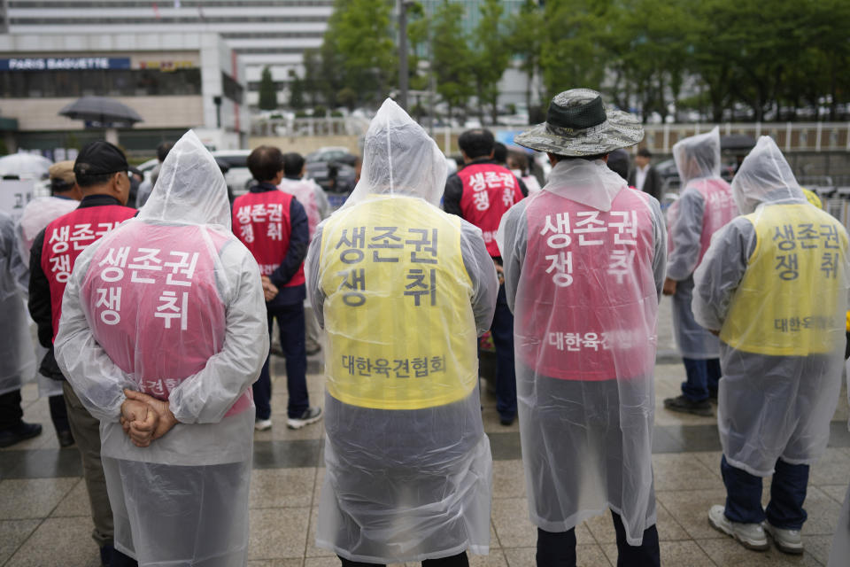 Members of the association of dog farmers, attend at a rally in Seoul, South Korea, Tuesday, April 25, 2023. The letters read " Win, Right to Live." and "Association of dog farmers." Dozens of dog farmers in South Korea rallied Tuesday to criticize the country’s first lady over her reported comments that support a possible ban on dog meat consumption. (AP Photo/Lee Jin-man)