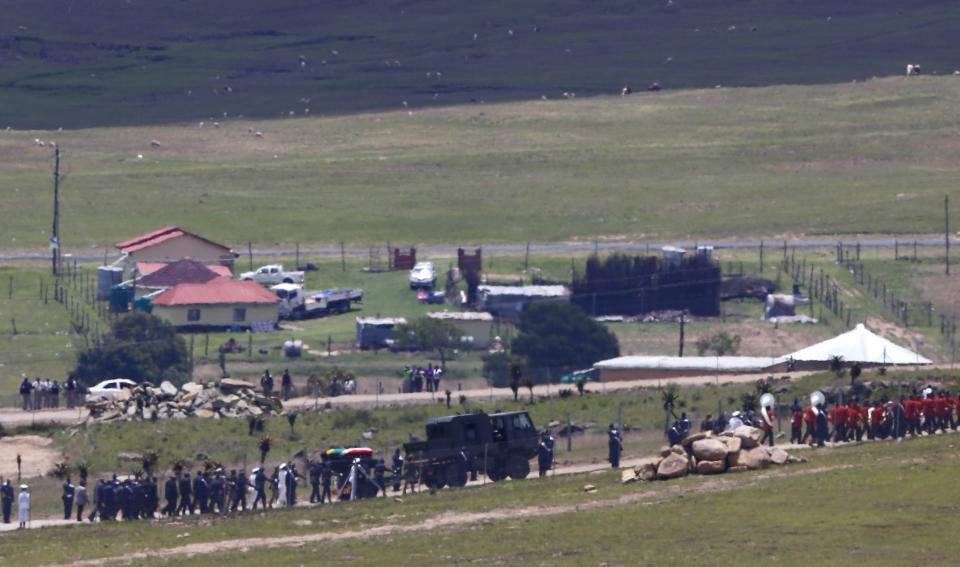 The funeral cortege carrying the coffin of former South African President Mandela makes its way to the graveyard within the Mandela family's property in the village of Qunu