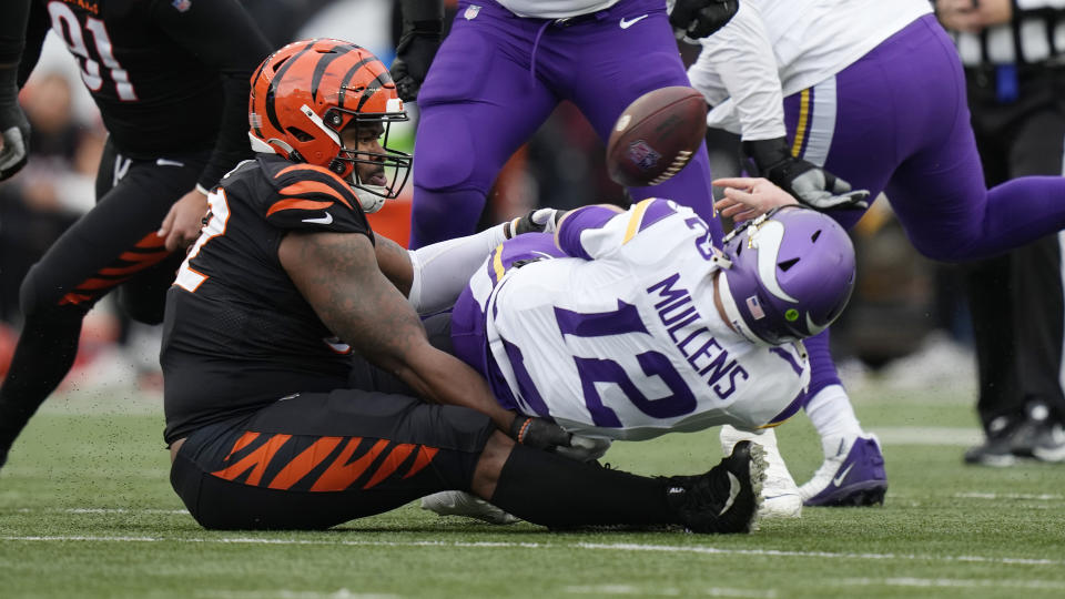 Minnesota Vikings quarterback Nick Mullens (12) fumbles as he is sacked by Cincinnati Bengals defensive tackle BJ Hill (92) during the first half of an NFL football game Saturday, Dec. 16, 2023, in Cincinnati. Hill recovered the humble on the play. (AP Photo/Carolyn Kaster)