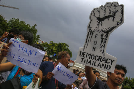 Demonstrators hold up signs during a protest against military rule at Victory Monument in Bangkok May 27, 2014. REUTERS/Athit Perawongmetha