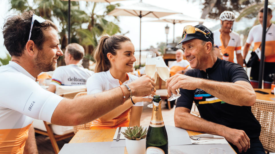 Cycling leaders Adam Blythe, Monica Dew, and Johan Museeuw kick back