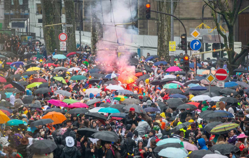 Young carnivalists celebrate the opening of the street carnival on Weiberfastnacht (Women's Carnival Day) on Zuelpicher street despite the rain. Thomas Banneyer/dpa