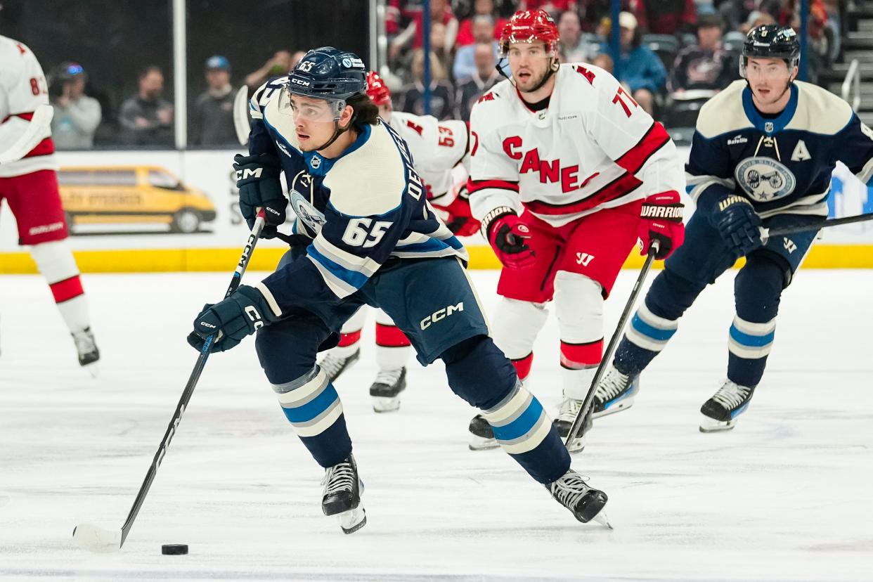 Apr 16, 2024; Columbus, Ohio, USA; Columbus Blue Jackets center Luca Del Bel Belluz (65) brings the puck up ice during the first period of the NHL hockey game against the Carolina Hurricanes at Nationwide Arena.