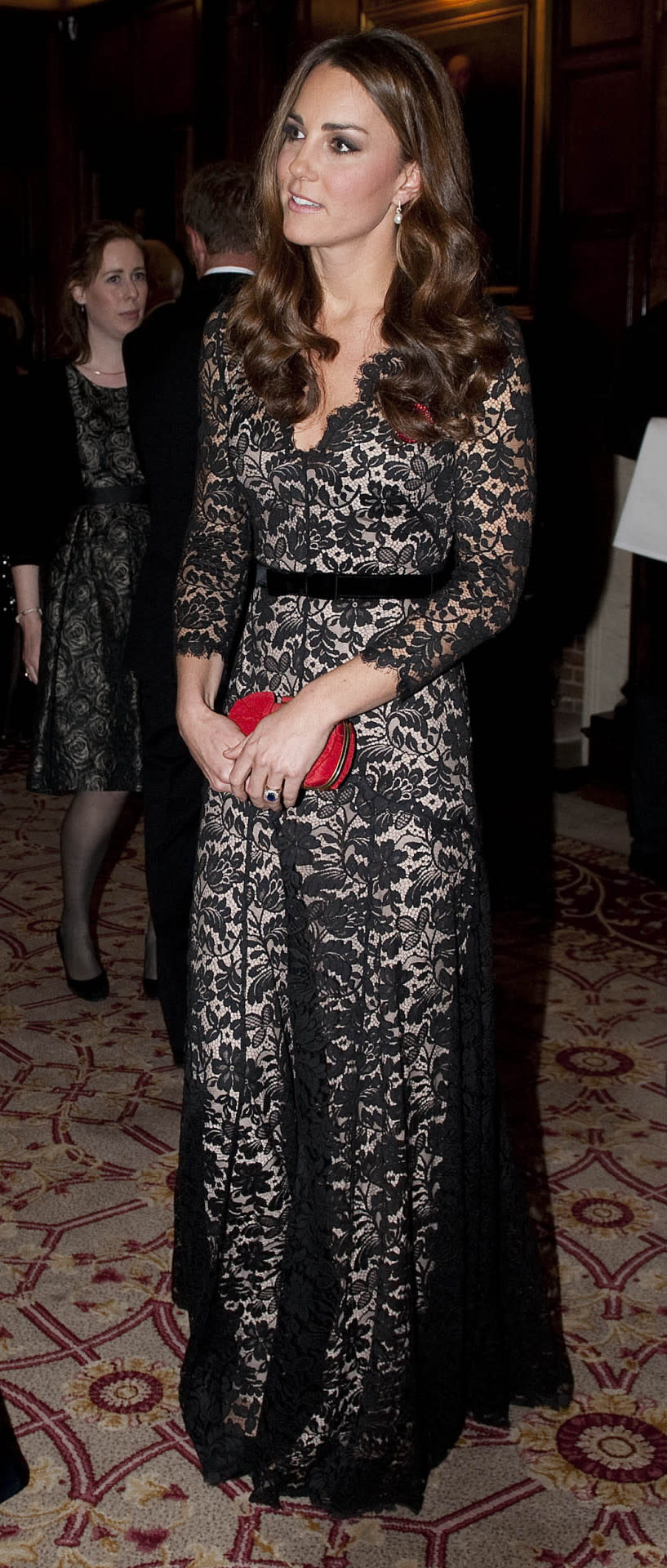 <p>The Duchess went back to St Andrews University for a dinner wearing a gorgeous nude-and-black lace gown by Temperley London. She carried a red Alexander McQueen box clutch and finished with suede Jimmy Choos.</p><p><i>[Photo: PA]</i></p>