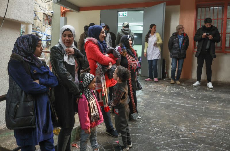 Palestinians queue at a UNRWA health center inside Burj al-Barajneh refugee camp in Beirut