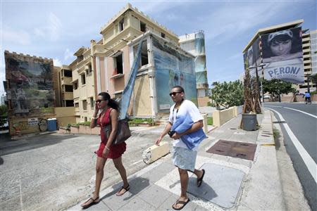 Advertising covers part of the abandoned structure of an unfinished condominium in the Condado tourist district of San Juan, August 31, 2013. REUTERS/Alvin Baez